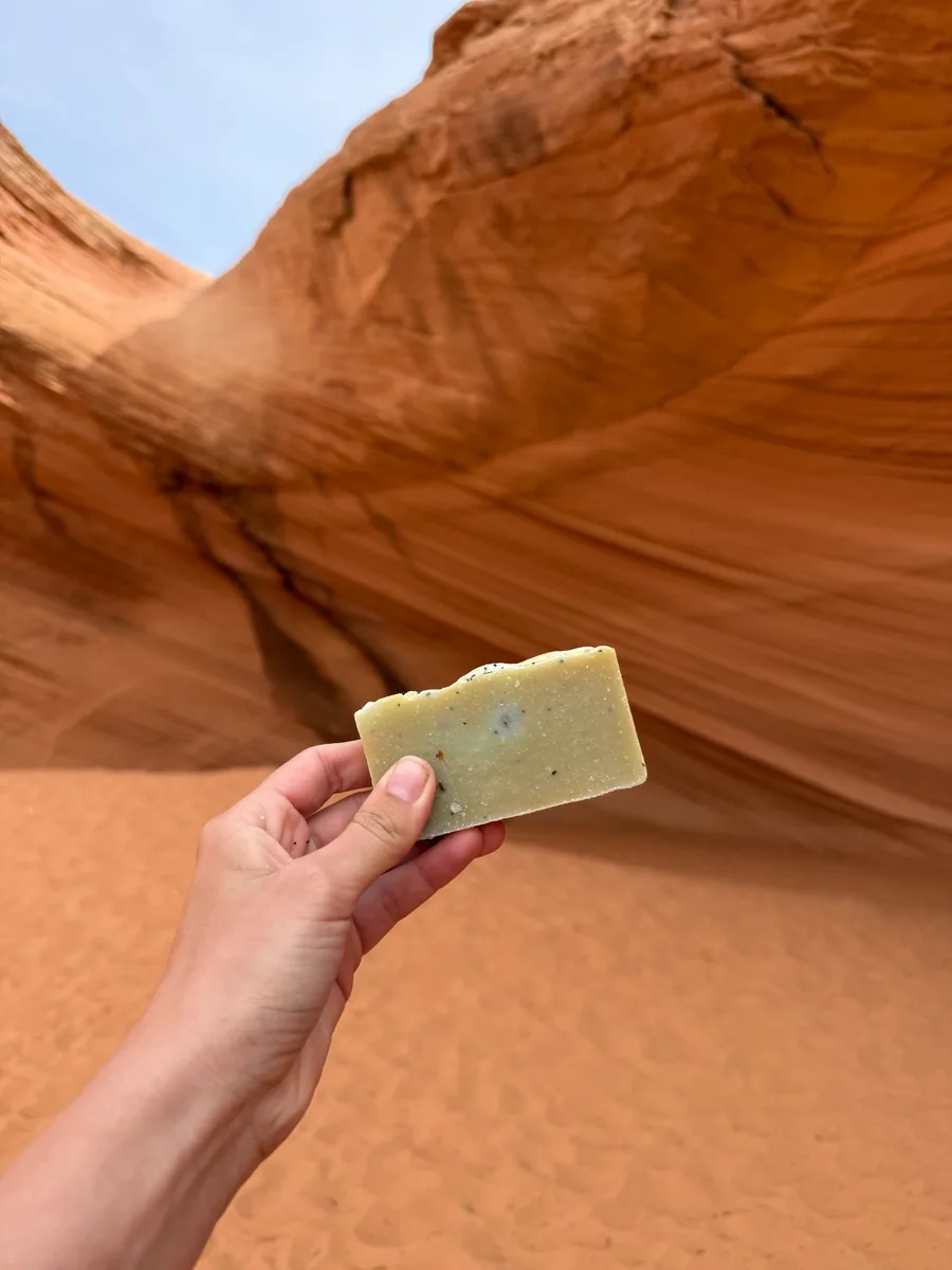 Handmade bar soap — sage green with texture, red rock background