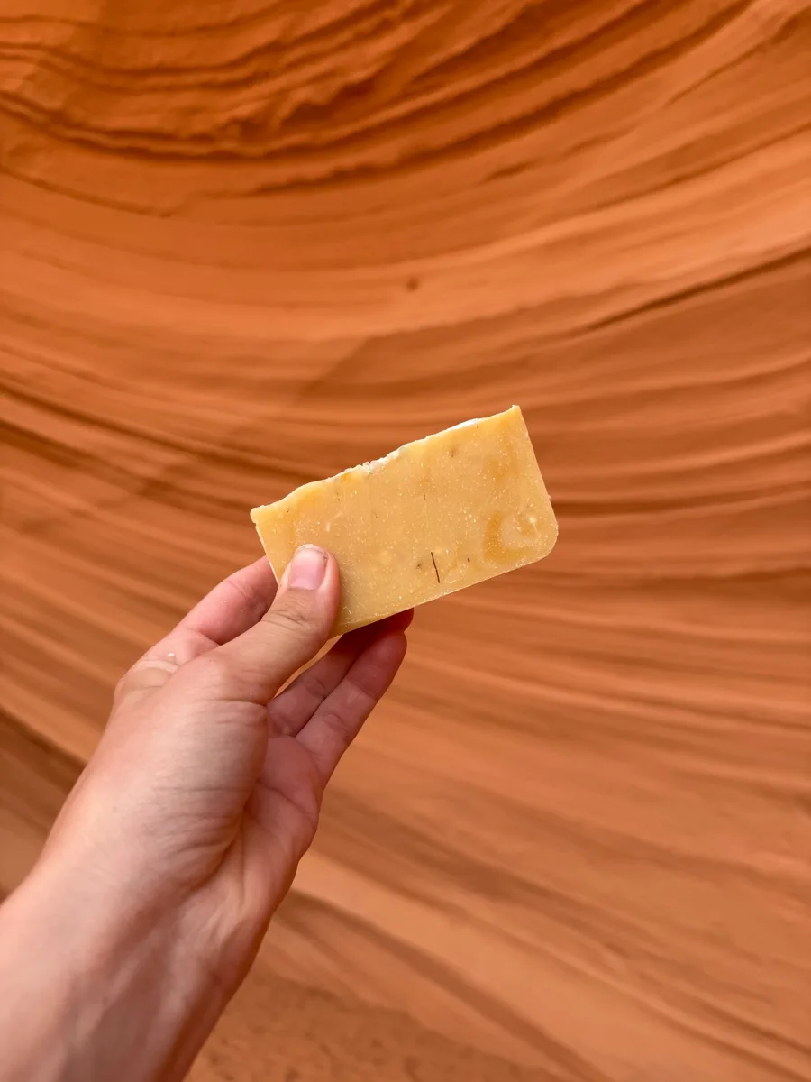 Handmade bar soap — warm amber tones against swirling sandstone