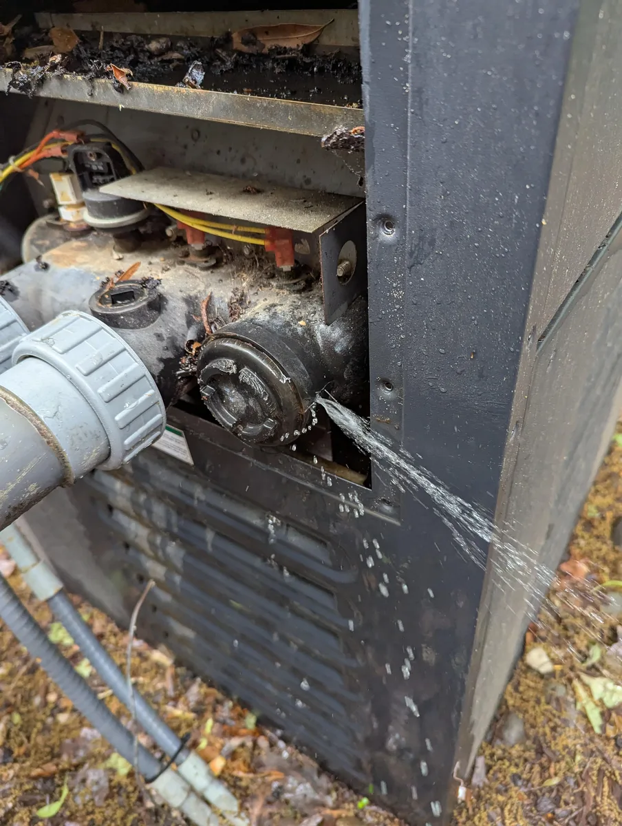 Active water leak at a pool equipment pipe joint